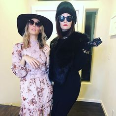 two women wearing hats and sunglasses posing for the camera