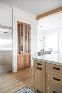 a kitchen with wooden cabinets and stainless steel refrigerator freezer next to an open door