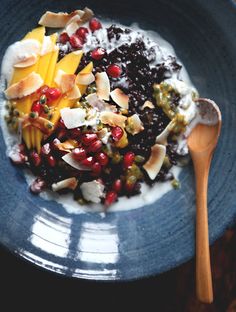 a blue plate topped with fruit and yogurt