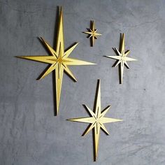 three gold stars are hanging on the wall