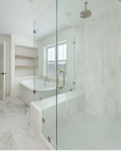 a large bathroom with a walk in shower next to a bathtub