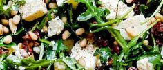 a salad with spinach, chickpeas, and feta cheese on it