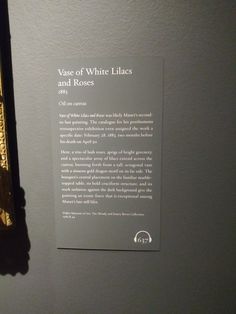 a sign on the wall that says, yare of white lines and roses with gold trim