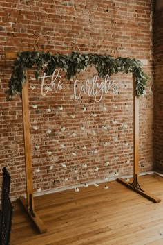 a wooden sign that says let's cuddle on it in front of a brick wall