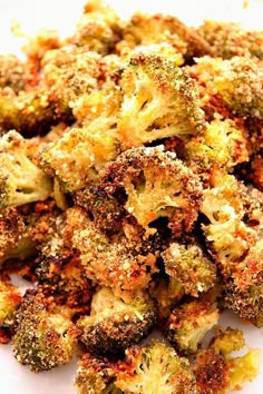 broccoli florets on a white plate with seasoning sprinkled