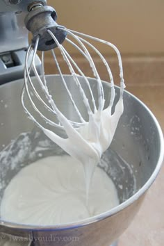 a whisk is being stirred in a metal bowl