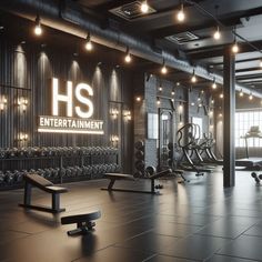 an empty gym with benches and exercise equipment in front of the wall that says h s entertainment