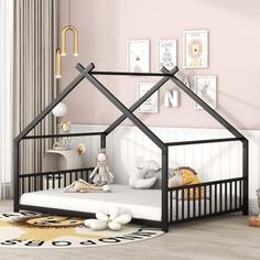 a child's bedroom with a black dollhouse bed and white rug on the floor