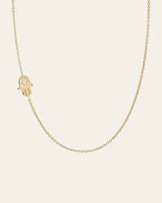 Chic and classic with a modern twist. A 14k solid gold asymmetrical hamsa with a tiny diamond on a dainty cable link chain necklace with the length of your choice. Available in 14k yellow, white, and rose gold, it also makes for the perfect gift. Made in L.A. Size of Hamsa: Approx. 10mm(W) by 7mm(H) Weight: Approx. 2 grams Ships in 4-7 business days Rush orders ship in 2-4 business days Comes gift ready in a custom Zoe Lev jewelry box. *Eligible for return, per our policy. See here for details. Hamsa Jewelry Vivien Frank Jewelry, Hamsa And Star Of David Necklace, Hand Of Fatima Jewelry, Hamsa Necklace Gold, Hamsa Necklace, Tiny Diamond, Chain Link Necklace, Necklace Sizes, Natural Diamonds