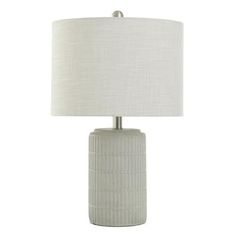 a table lamp with a white shade on it