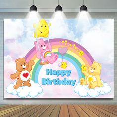 there is a happy birthday banner with teddy bears and rainbows on the wall behind it