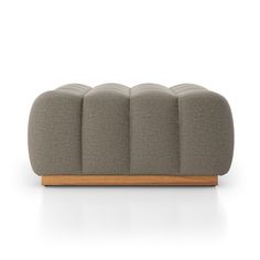 an upholstered sofa with four seats on the bottom and one arm, in grey fabric