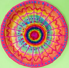 a colorful paper plate on a green surface