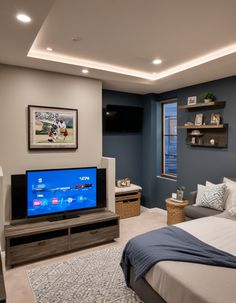 a bedroom with blue walls and a large flat screen tv