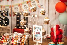 there is a ferris wheel on the table with candy and candies in front of it