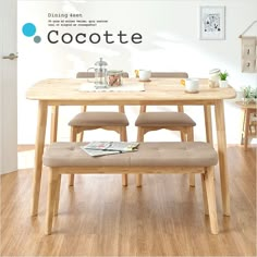 a wooden table with four chairs and a bench in front of it that says cocoate