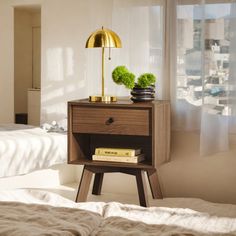 a bedroom with a bed, nightstand and window