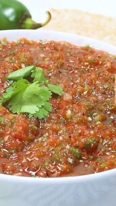 a white bowl filled with salsa and cilantro