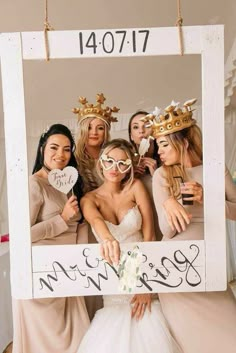 a group of women wearing crowns and holding up a sign with the word bride written on it