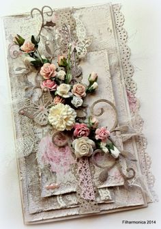 an altered card with flowers and lace on it