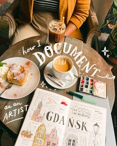 a person sitting at a table with an open book and cup of coffee in front of them