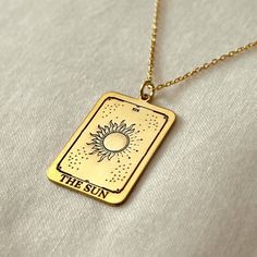 a gold necklace with the sun on it