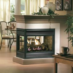 a living room filled with furniture and a fire place in the middle of a room