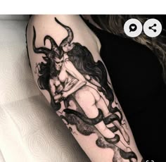 a woman's arm with a tattoo on it and an image of a demon