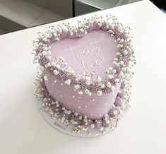 a heart shaped cake with flowers on top