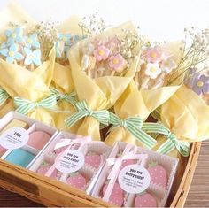 some flowers and cookies are sitting in a basket on the table next to each other