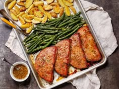 a pan filled with meat, potatoes and green beans