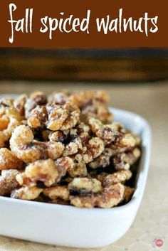 a white bowl filled with nuts on top of a table