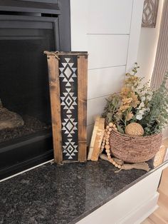 a basket with flowers sitting on top of a counter next to a fireplace mantel