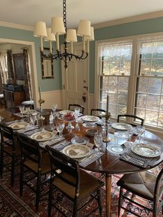 the dining room table is set with dishes and place settings for six people to eat