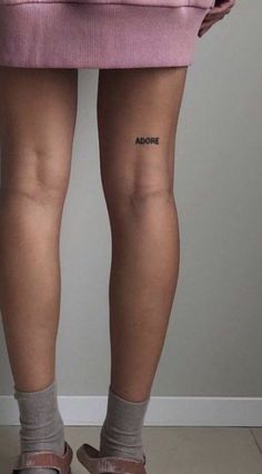 the back of a woman's legs with an inscription on her left leg that reads aoonie