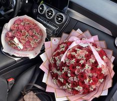 a bouquet of roses is sitting on the dashboard of a car next to a purse