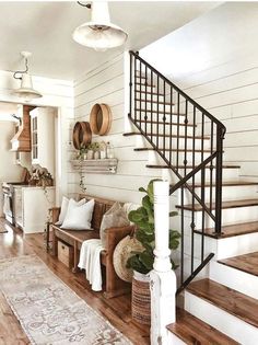 a living room filled with furniture next to a stair case