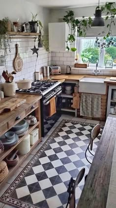 an instagram photo of a kitchen with black and white checkered flooring