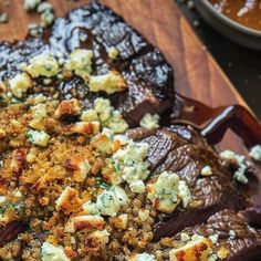 a wooden platter filled with food on top of a table