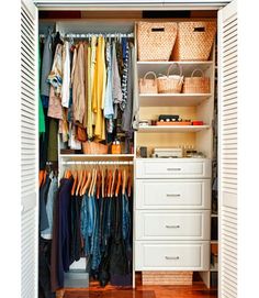 an open closet with clothes and baskets on the shelves in front of it is shown