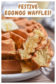 a white plate topped with waffles next to a fork and glass of milk