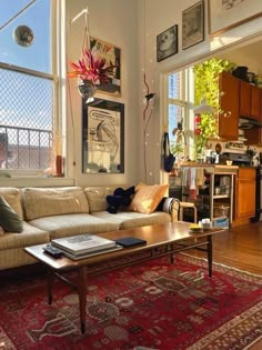 a living room filled with furniture and large windows