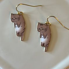 Cat Earrings Made With Enamel And Gold Plated Earwire. *Cat 1” *Gold Plated Earwire Adjustable Cute Cat Design Earrings, Cute Adjustable Cat Design Earrings, Cute Cat Design Adjustable Earrings, Adjustable Cat Ears Earrings For Gift, Adjustable Cat Ears Earrings As Gift, Metal Cat Design Drop Earrings, Gold Metal Cat Design Earrings, Gold Metal Earrings With Cat Design, Cute Brown Dangle Earrings