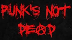 the words punk is not dead written in red ink