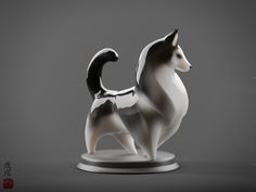 a white and black cat figurine sitting on top of a table next to a gray background