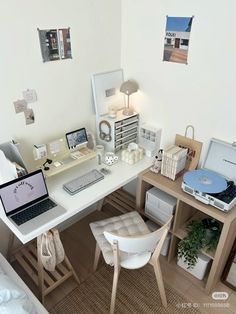 a white desk with a laptop computer sitting on top of it