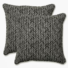 two black and white pillows sitting next to each other