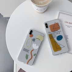 two iphone cases sitting on top of a table