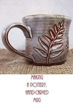 a coffee cup with leaves on it and the words making pottery hand - carved mug