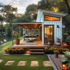 an outdoor living area is lit up with candles and potted plants in the foreground